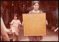Girl holding a board prepared for yarn painting